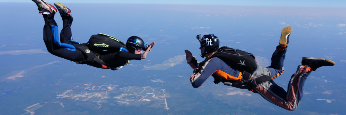 Two divers in freefall where one is instructing the other